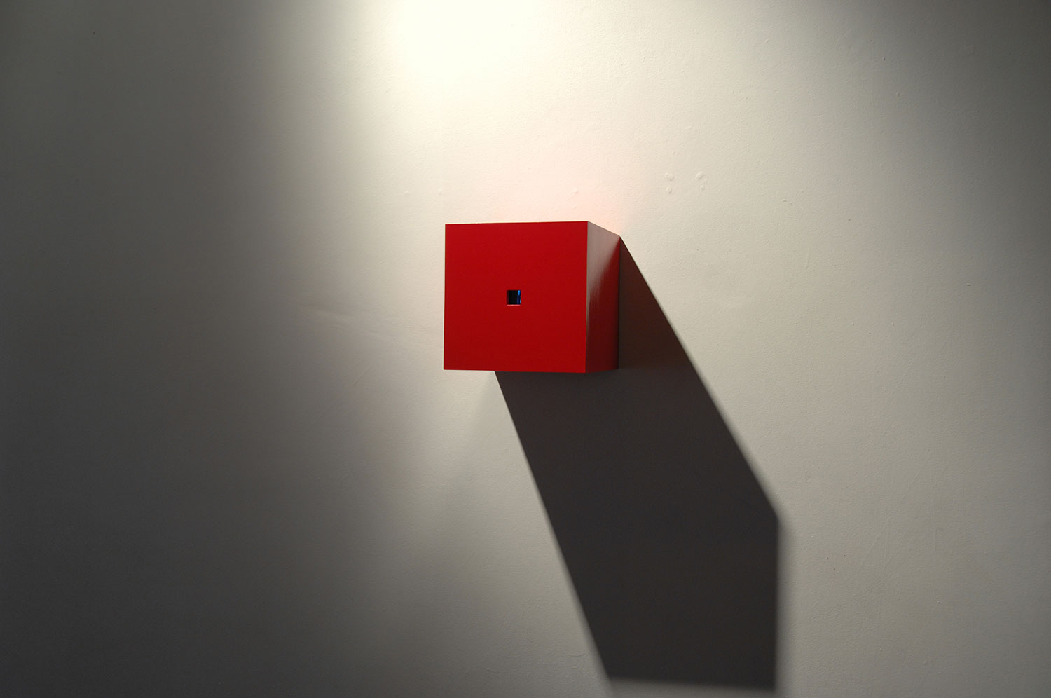 Existential Dilemma, 2003, video installation, two-channel, red box 11 x 11 x 11.5<br><br>Go to menu, click VIDEOS, to watch excerpts<br><br>Peek inside the box to find us continuously flipping inside a box that imposes laws of constraint.