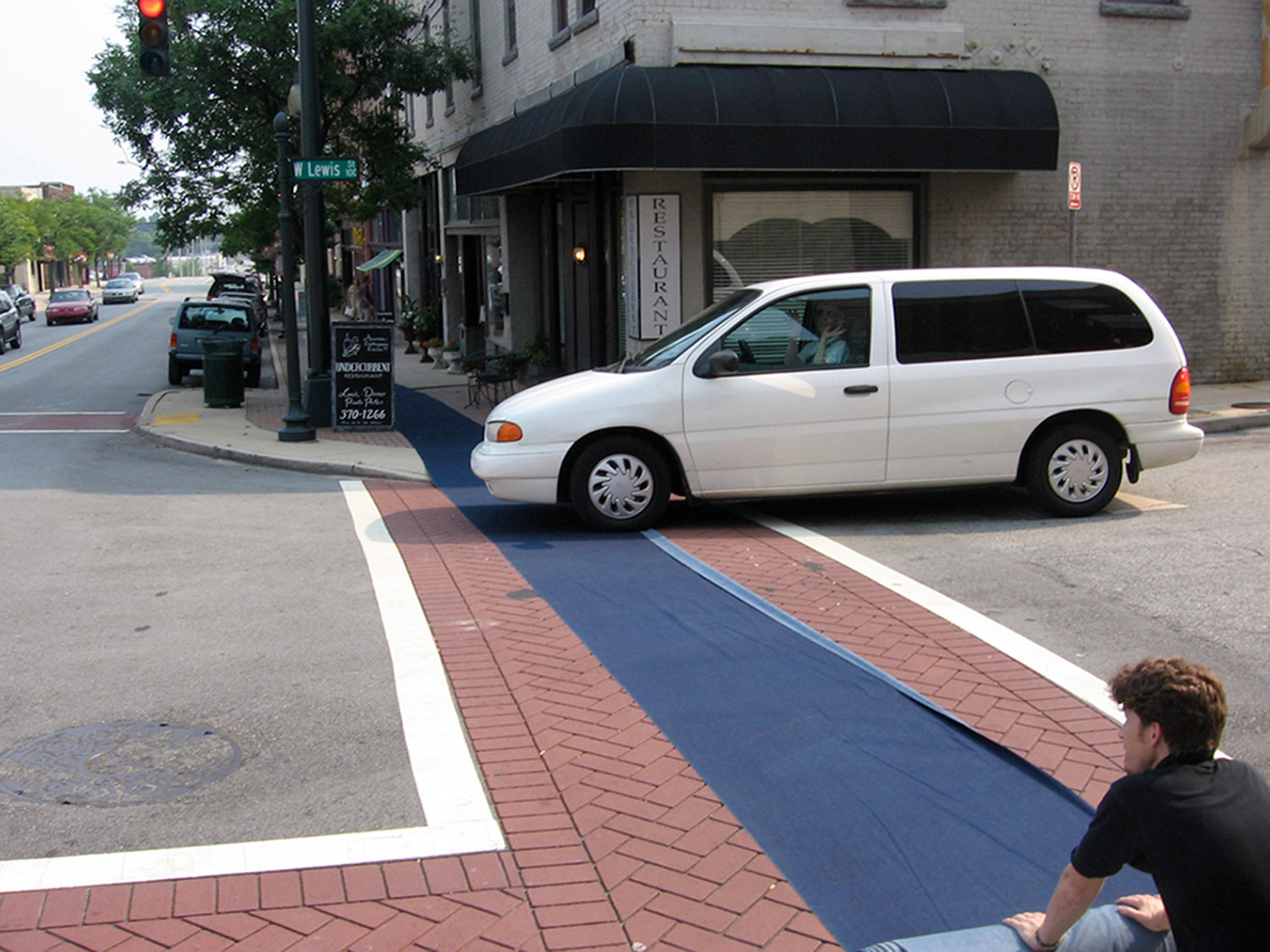 Labor, 2006, live performance at Elsewhere<br><br>For five days outside of Elsewhere (Greensboro, NC), I rolled out a spool of denim fabric that span roughly a block and a half, and then rolled the fabric back up. On the fifth day, the unrolling was photographed.